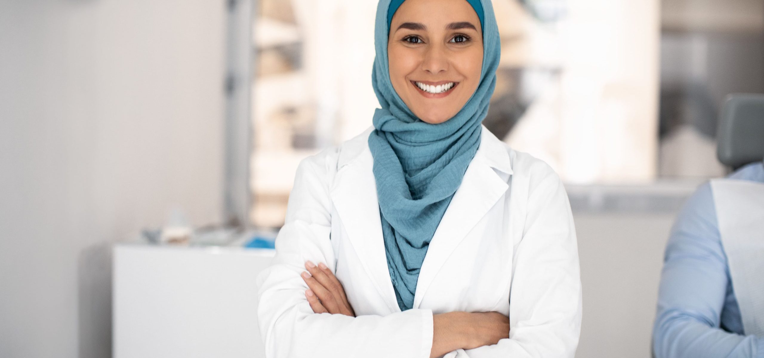 Smiling female doctor with arms crossed, representing TheKnowHow’s partnership with healthcare professionals in providing expert medical opinions.
