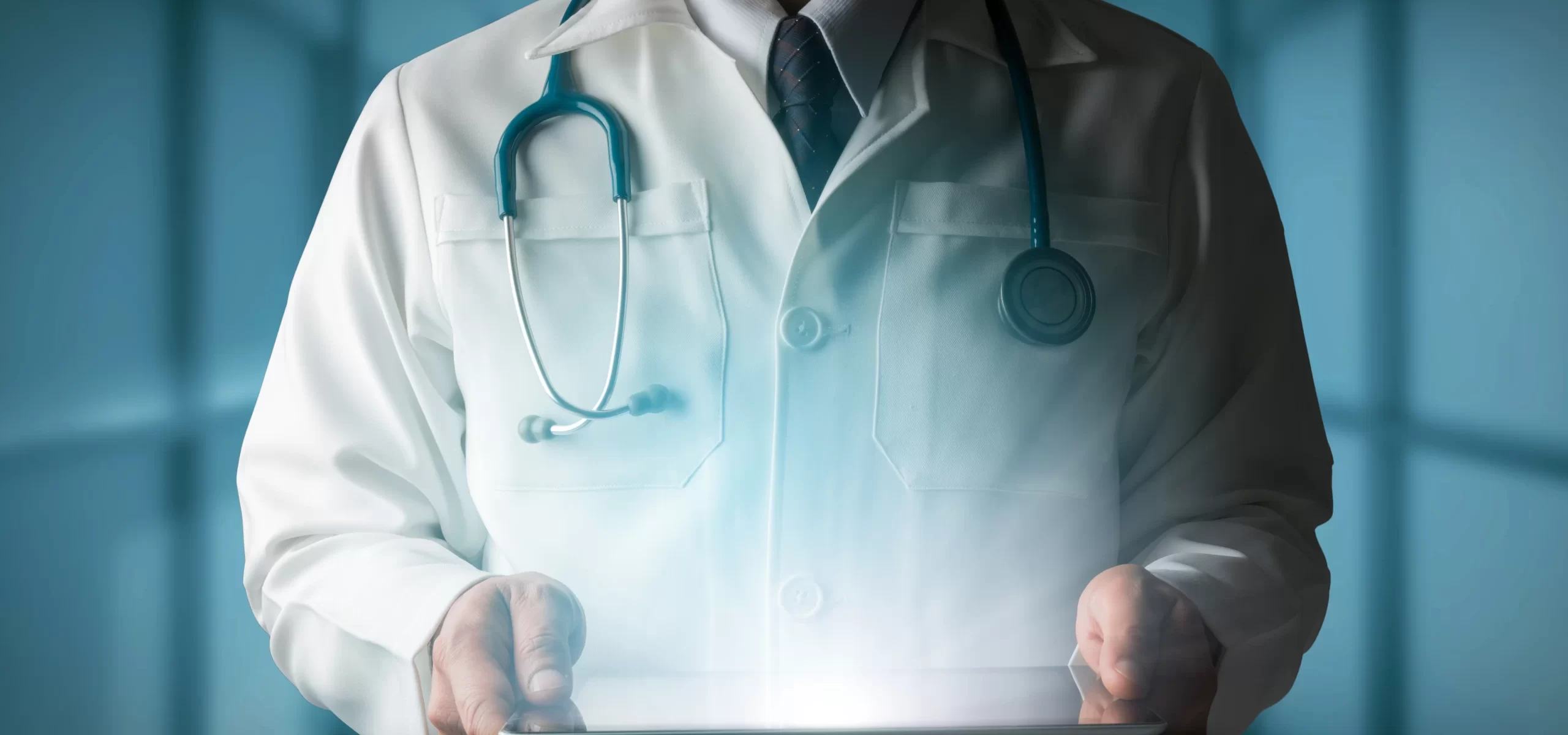 Doctor in a white coat holding a digital tablet, representing TheKnowHow in Abu Dhabi, a medical field intermediary.